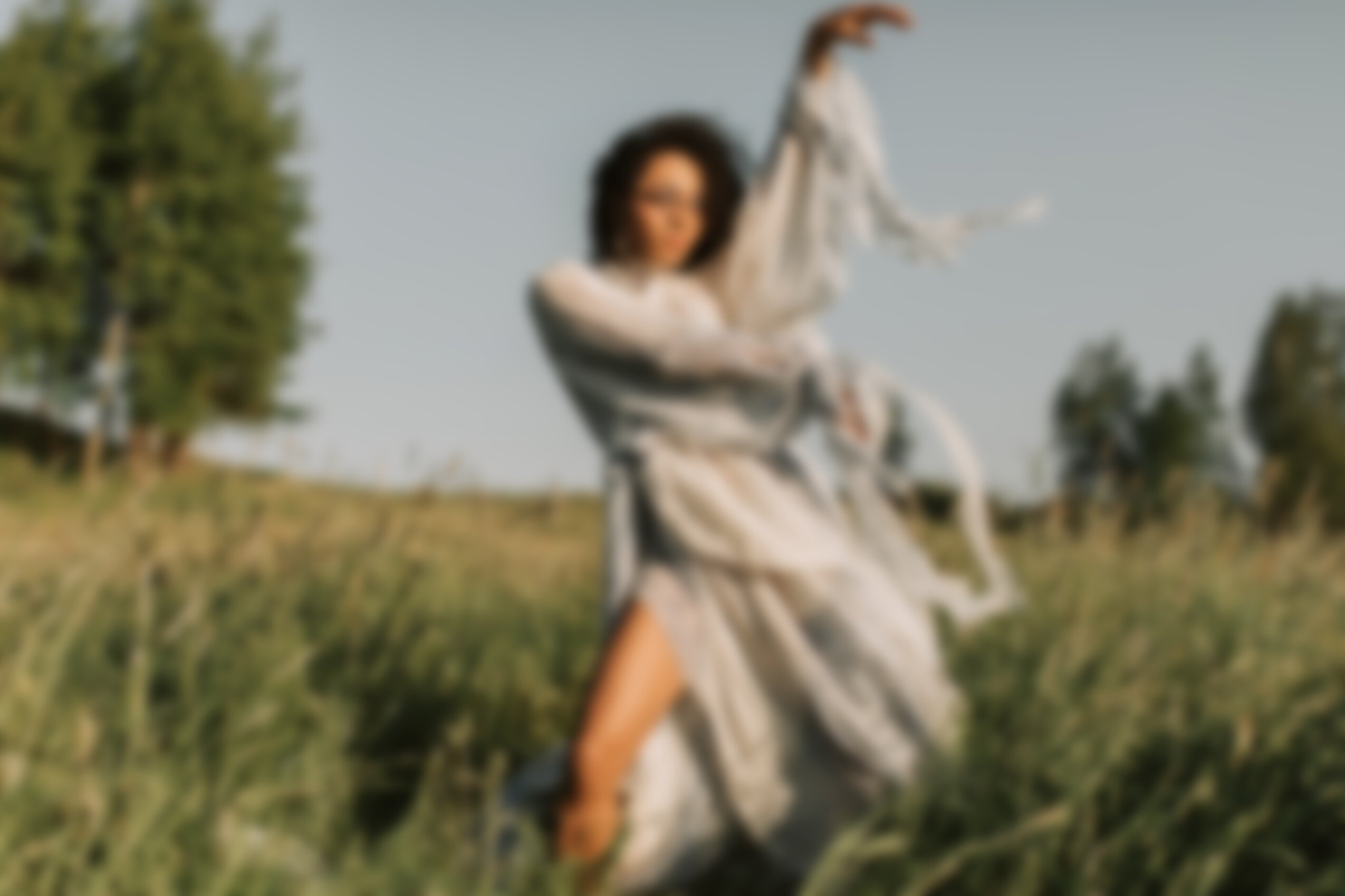 Woman in White Dress Posing on Grass Field 